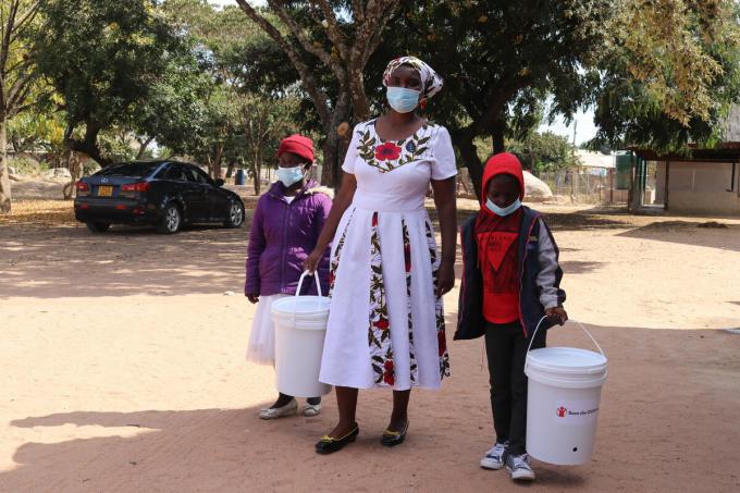 Elvis, Elsa and their aunt after receiving hygiene kits 