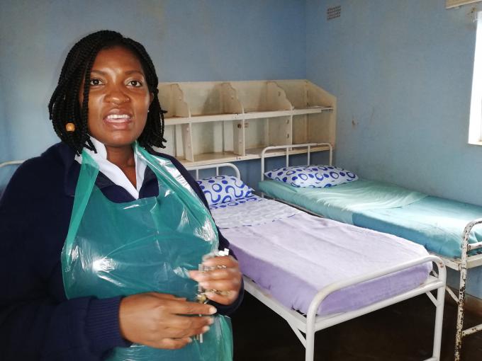 Lucia Gulugulu the Nurse in Charge at Ngorima Clinic shows some of the beds and blankets  which they received from Save the Children