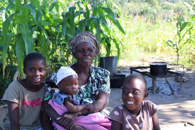 Nokwanda 10 (L) with her Grandmother Margaret*, sister Khanyisiwe* (R) and baby cousin Nondi* at their outside cooking fire