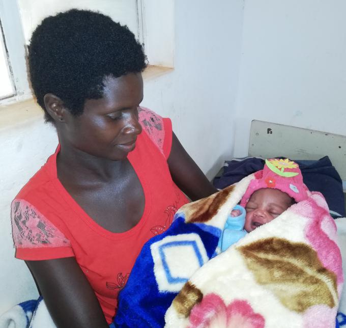 Tapiwa Mashava holds her newly born baby at  Junction Gate Clinic